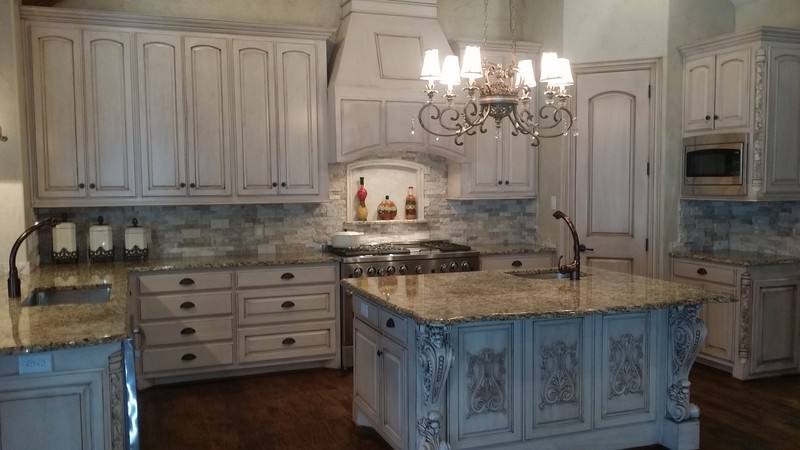 This is an example of a large traditional u-shaped eat-in kitchen in Dallas with raised-panel cabinets, granite benchtops, beige splashback, stainless steel appliances, dark hardwood floors, with island, brown floor, an undermount sink, beige cabinets, stone tile splashback and multi-coloured benchtop.