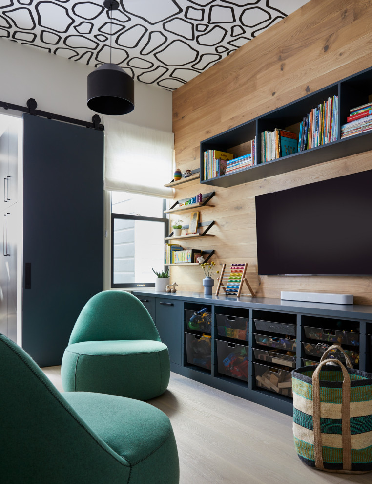 Photo of an expansive contemporary gender-neutral kids' playroom for kids 4-10 years old in San Francisco with light hardwood floors, wallpaper and wood walls.