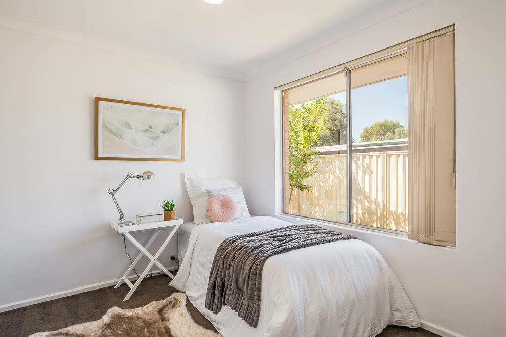 This is an example of a contemporary kids' room for girls in Perth with white walls, carpet and grey floor.