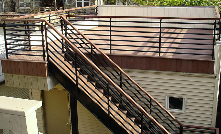 Transitional wooden and rooftop straight deck photo in Chicago with wooden risers