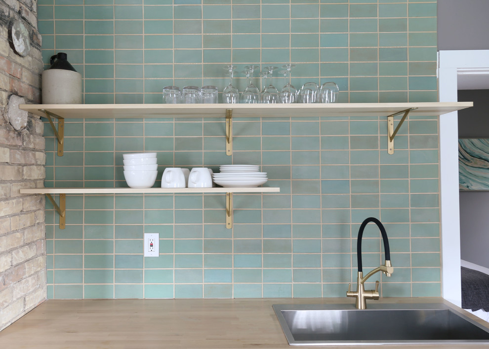 Small transitional l-shaped light wood floor and brown floor open concept kitchen photo in Minneapolis with a drop-in sink, flat-panel cabinets, white cabinets, wood countertops, green backsplash, ceramic backsplash, stainless steel appliances, no island and brown countertops