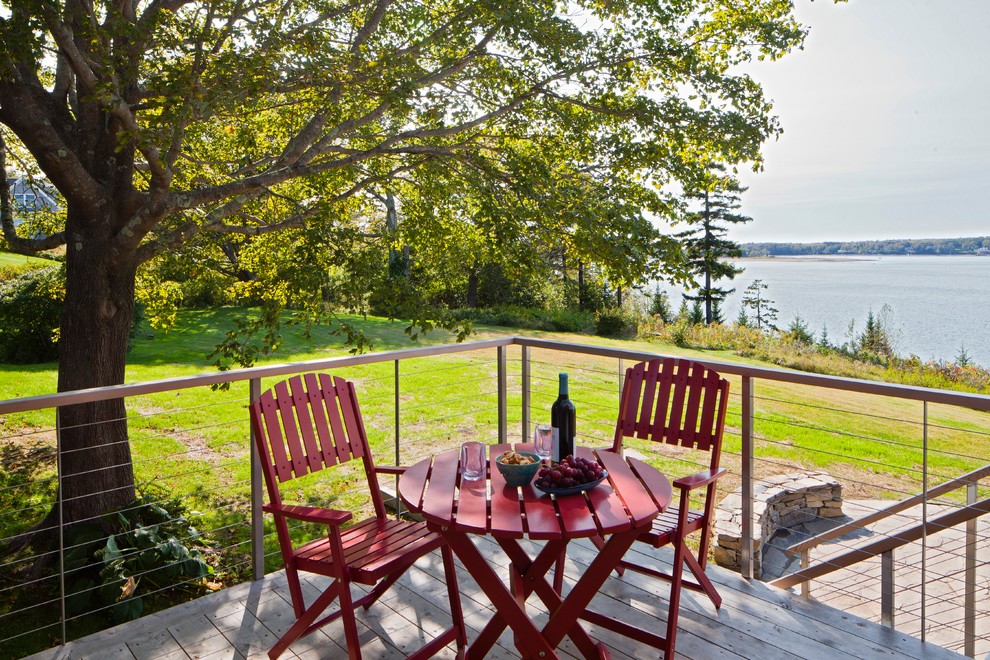 Design ideas for a beach style backyard deck in Portland Maine with no cover.