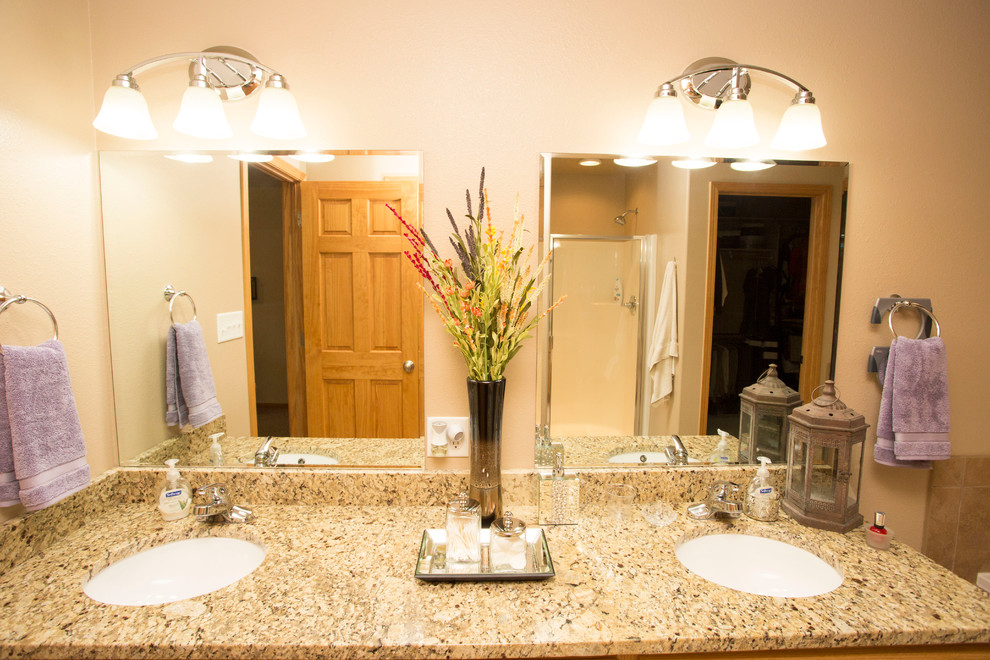 Example of a large transitional master beige tile bathroom design with raised-panel cabinets, light wood cabinets and granite countertops