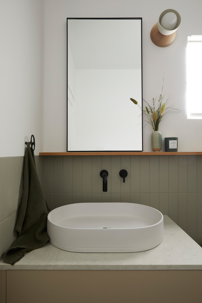 Powder room - small scandinavian green tile and porcelain tile terrazzo floor, gray floor and single-sink powder room idea in San Francisco with flat-panel cabinets, blue cabinets, a one-piece toilet, white walls, a vessel sink, quartz countertops, a hinged shower door, gray countertops, a niche and a floating vanity