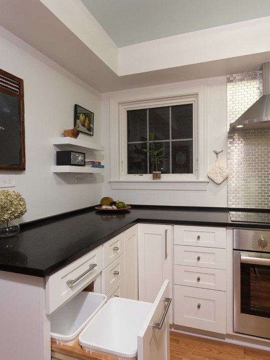Inspiration for a mid-sized transitional u-shaped medium tone wood floor enclosed kitchen remodel in Chicago with a double-bowl sink, shaker cabinets, white cabinets, quartzite countertops, gray backsplash, subway tile backsplash, stainless steel appliances and no island
