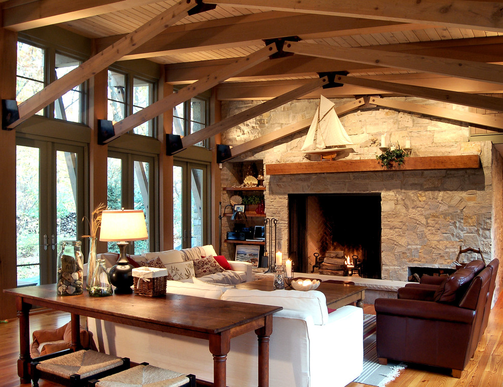 Country family room in Chicago with a stone fireplace surround.