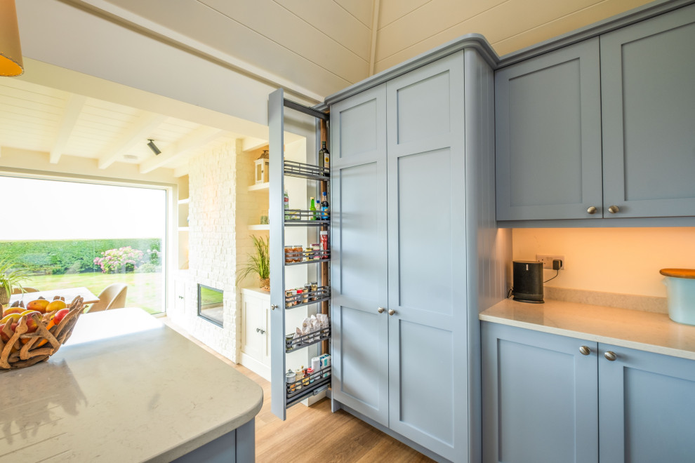 Photo of a beach style kitchen pantry in Sussex.