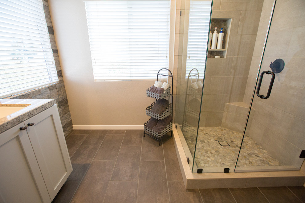 Contemporary bathroom in Sacramento with shaker cabinets, beige cabinets, a corner shower, porcelain flooring, a submerged sink, engineered stone worktops, brown floors, a hinged door and beige worktops.