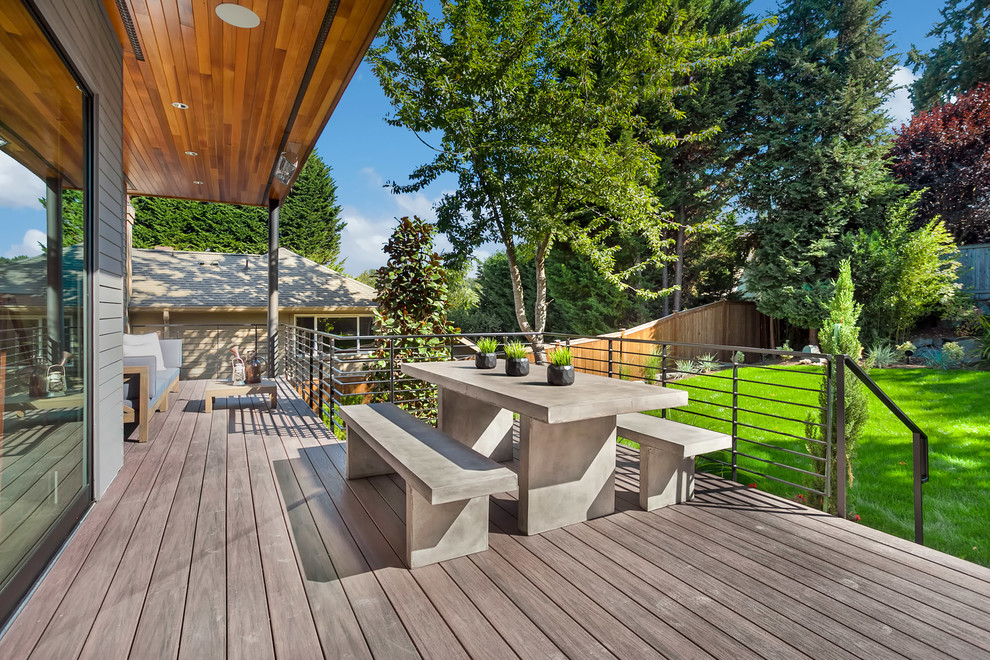 Deck - large contemporary backyard deck idea in Seattle with a roof extension