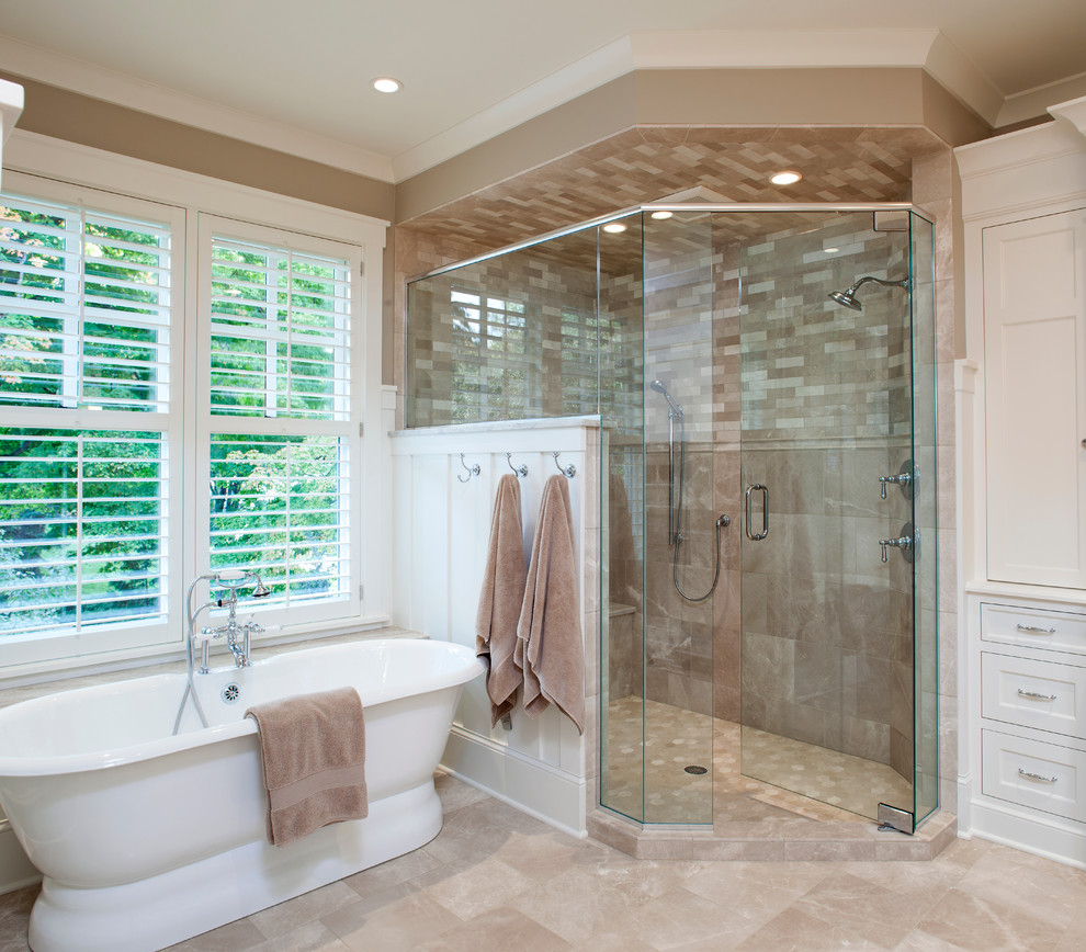 Design ideas for a mid-sized traditional master bathroom in Minneapolis with white cabinets, a freestanding tub, a corner shower, beige tile, stone tile, beige walls, travertine floors, an undermount sink, granite benchtops, beaded inset cabinets, beige floor and a hinged shower door.