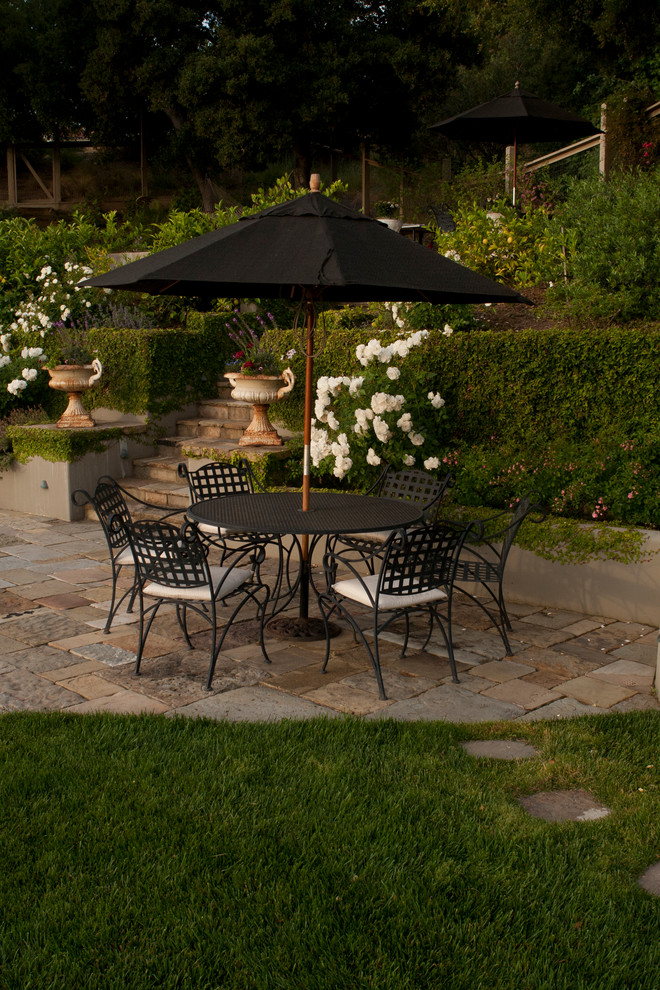 Inspiration for a large traditional backyard patio in San Francisco with no cover and natural stone pavers.