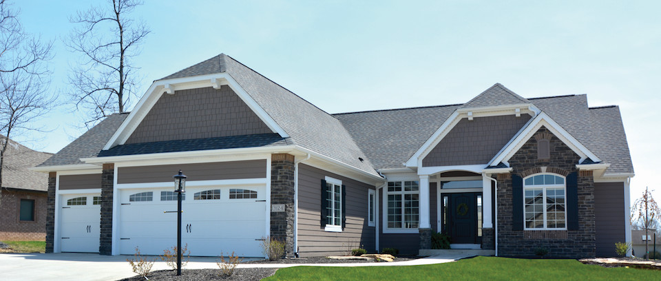 Mid-sized brown one-story vinyl house exterior idea with a clipped gable roof and a shingle roof