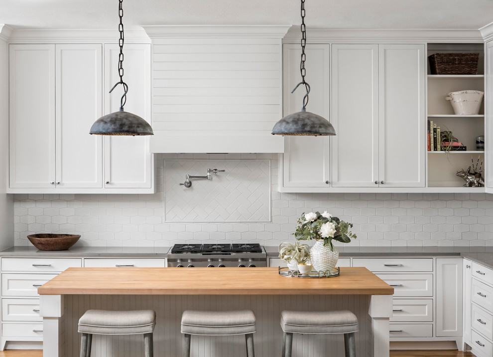 Inspiration for a large transitional l-shaped kitchen in Austin with shaker cabinets, white cabinets, white splashback, ceramic splashback, stainless steel appliances, with island and wood benchtops.