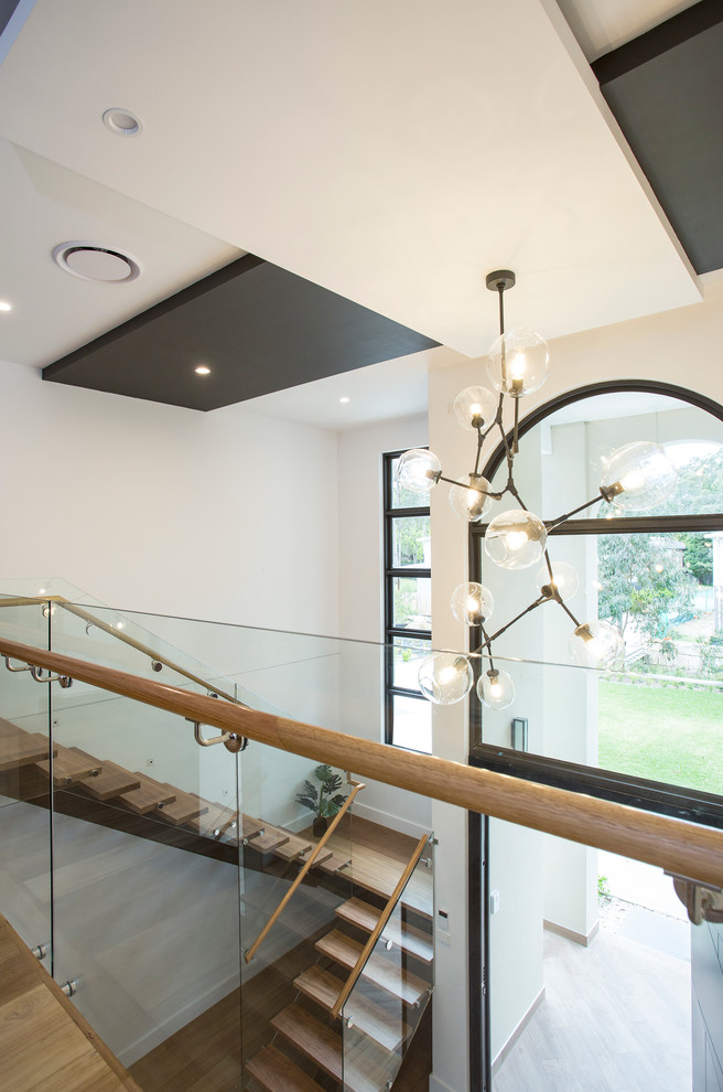 Modern wood u-shaped staircase in Sydney with wood risers.