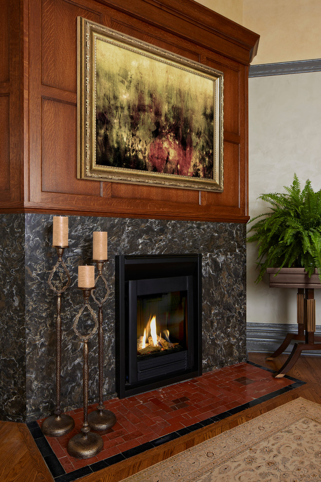 Inspiration for a traditional living room in Minneapolis with a stone fireplace surround.