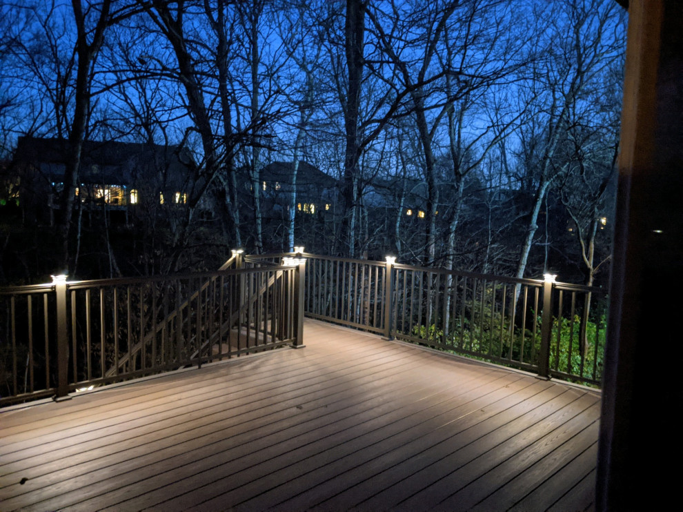 This is an example of a large traditional back first floor metal railing terrace in Cincinnati with a roof extension.