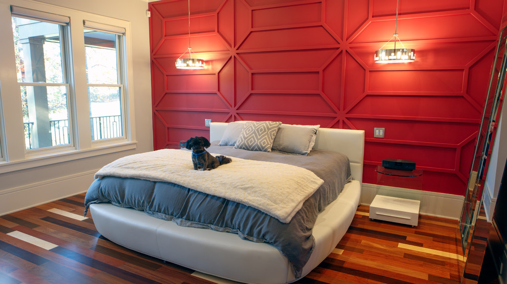 This is an example of a large modern master bedroom in Charlotte with red walls, light hardwood floors and multi-coloured floor.
