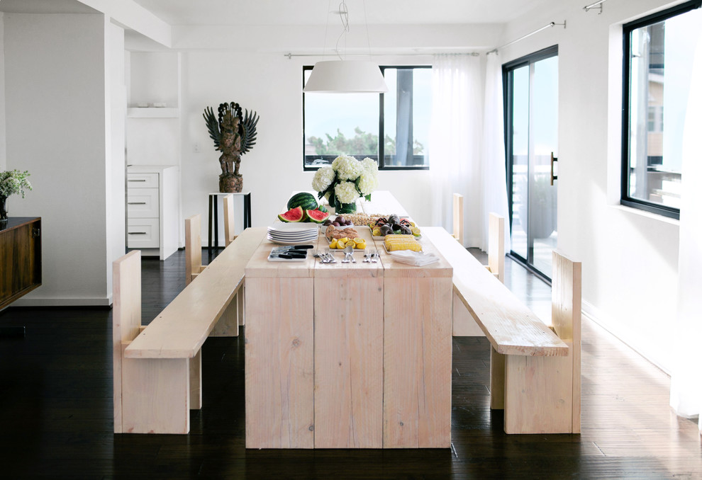 Inspiration for a beach style open plan dining in Los Angeles with white walls and dark hardwood floors.