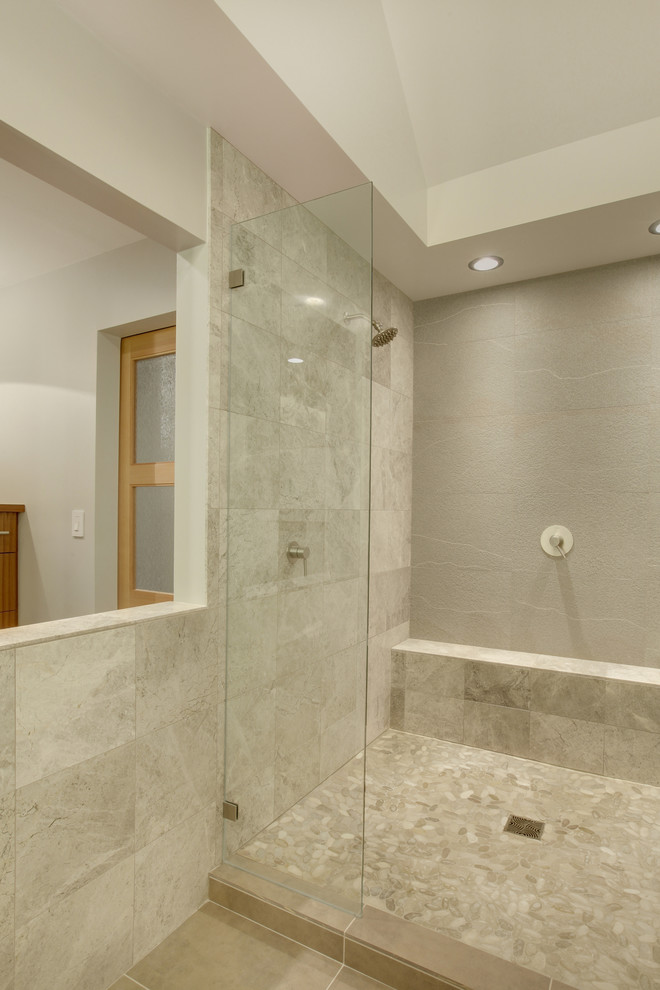 Photo of a large modern master bathroom in Seattle with a vessel sink, flat-panel cabinets, medium wood cabinets, tile benchtops, a double shower, gray tile, stone tile and pebble tile floors.