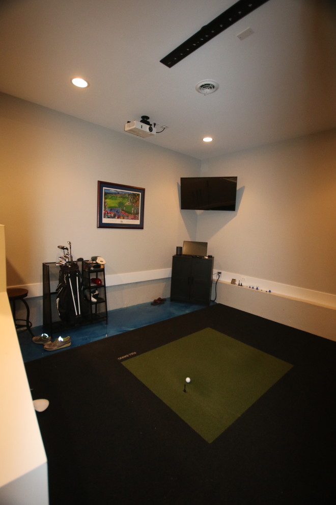 Example of a mid-sized transitional look-out basement game room design in Chicago with a wall-mounted tv and gray walls