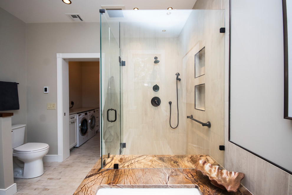 Inspiration for an expansive country master bathroom in Providence with furniture-like cabinets, white cabinets, a drop-in tub, a corner shower, a two-piece toilet, beige tile, porcelain tile, beige walls, porcelain floors, a vessel sink, wood benchtops, white floor and a hinged shower door.