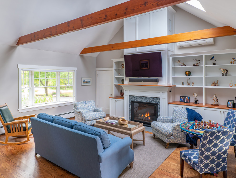 Mid-sized transitional open concept family room in Boston with grey walls, medium hardwood floors, a standard fireplace, a stone fireplace surround and a wall-mounted tv.