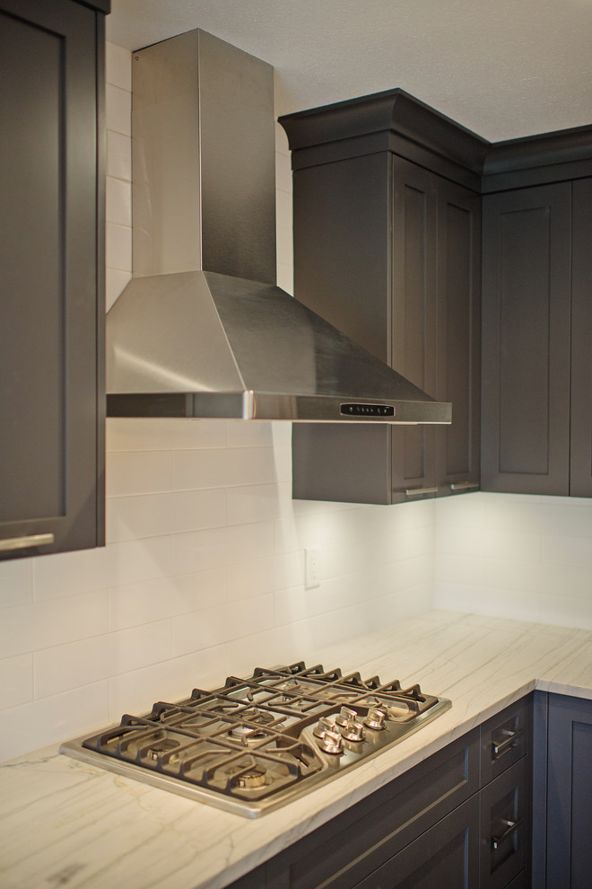 Eat-in kitchen - mid-sized transitional l-shaped eat-in kitchen idea in Vancouver with a single-bowl sink, shaker cabinets, gray cabinets, marble countertops, white backsplash, stainless steel appliances and an island