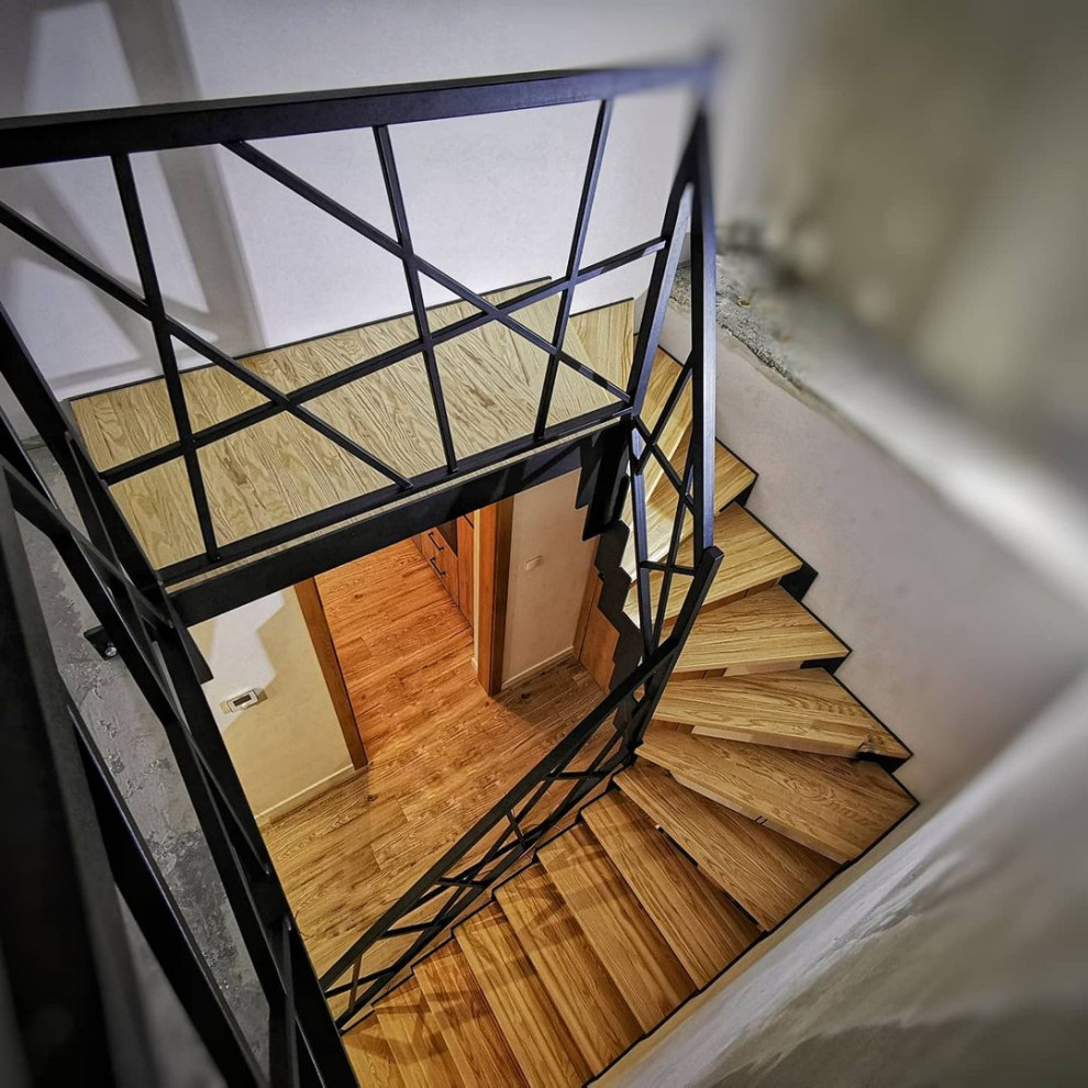 Inspiration for a medium sized urban wood l-shaped metal railing staircase in Moscow with wood risers.