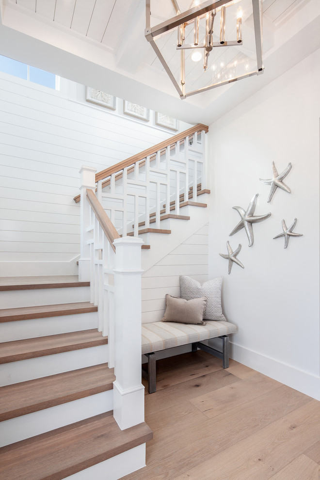 Design ideas for a beach style wood l-shaped staircase in Other with painted wood risers and wood railing.