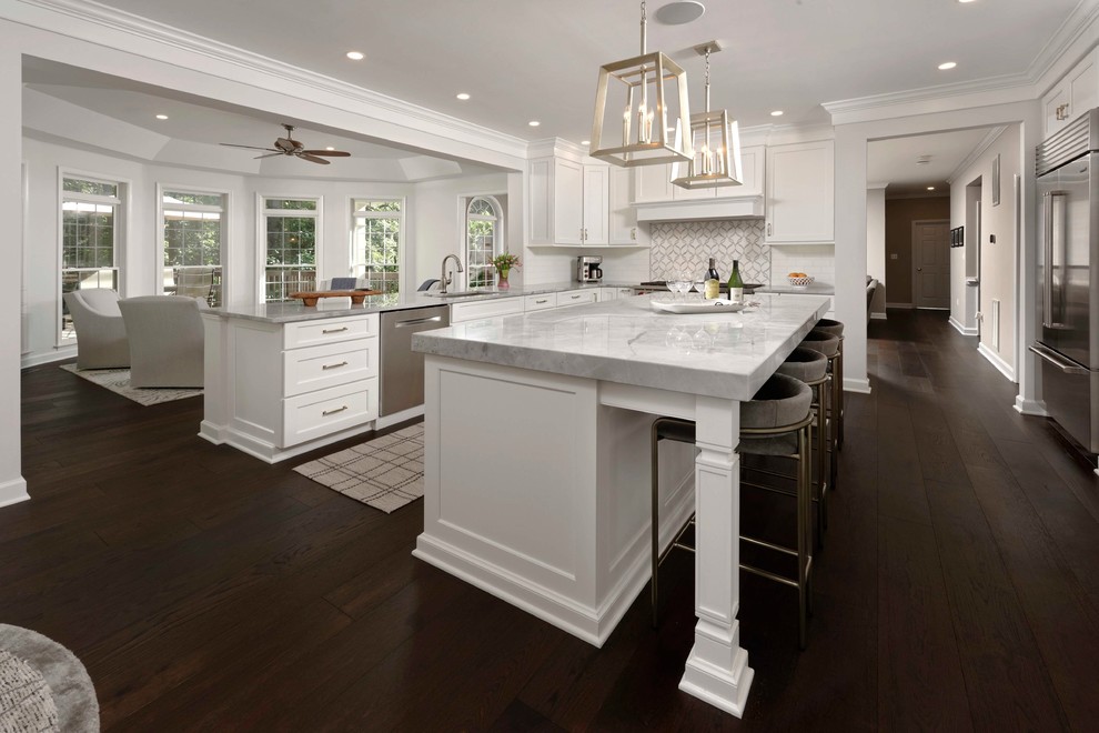 Inspiration for a large transitional l-shaped eat-in kitchen in Jacksonville with an undermount sink, flat-panel cabinets, white cabinets, marble benchtops, grey splashback, marble splashback, stainless steel appliances, dark hardwood floors, with island, brown floor and grey benchtop.