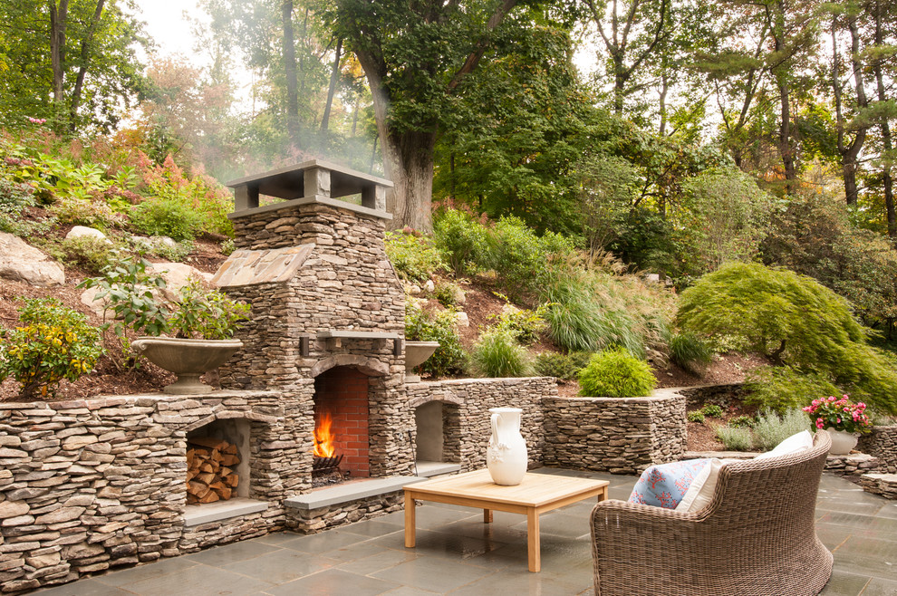 Photo of a traditional patio in New York with no cover and with fireplace.