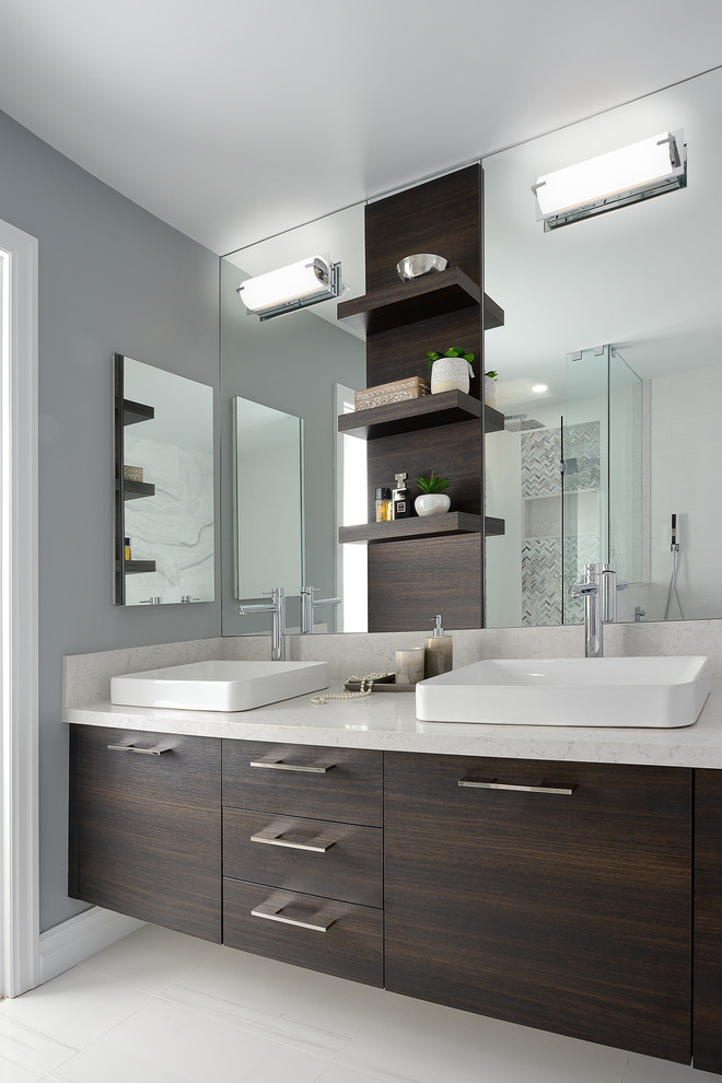 This is an example of a transitional bathroom in Toronto with flat-panel cabinets, dark wood cabinets, grey walls, a vessel sink, beige floor and beige benchtops.