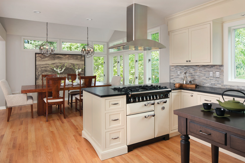 Transitional eat-in kitchen photo in Detroit with beaded inset cabinets, beige cabinets, matchstick tile backsplash, white appliances and multicolored backsplash