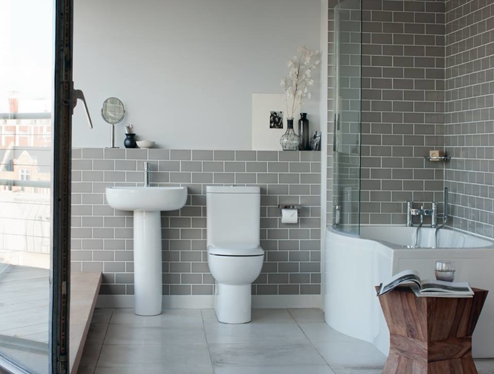 Design ideas for a mid-sized contemporary kids bathroom in Cambridgeshire with flat-panel cabinets, white cabinets, a drop-in tub, a curbless shower, a one-piece toilet, gray tile, porcelain tile, grey walls, marble floors and a pedestal sink.