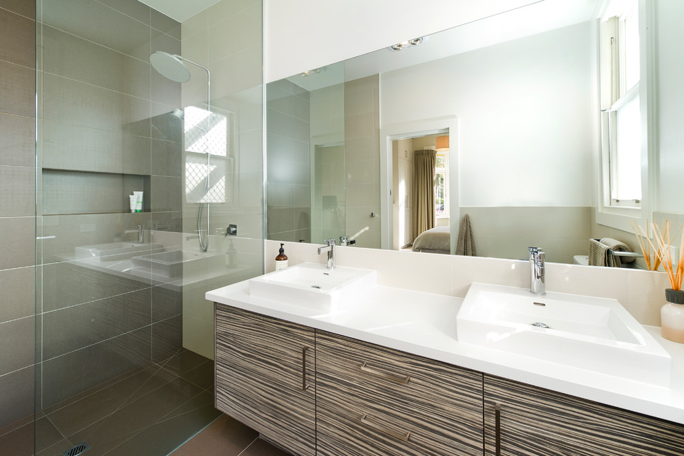 Design ideas for a mid-sized contemporary master bathroom in Melbourne with a vessel sink, a curbless shower, white walls, raised-panel cabinets, medium wood cabinets, a one-piece toilet, brown tile, porcelain tile, porcelain floors and engineered quartz benchtops.