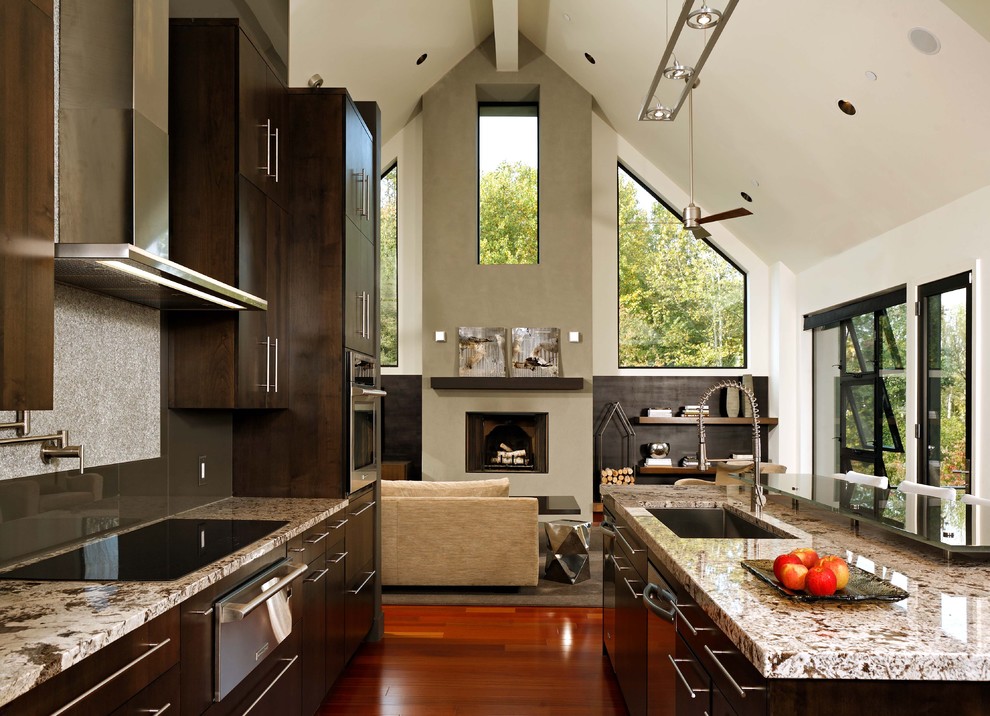 Inspiration for a large contemporary l-shaped open plan kitchen in DC Metro with granite benchtops, an undermount sink, flat-panel cabinets, dark wood cabinets, brown splashback, glass sheet splashback, stainless steel appliances, medium hardwood floors, with island and brown floor.