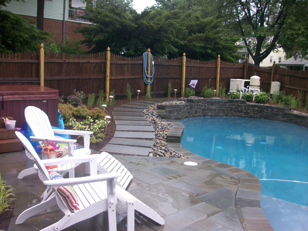 Large transitional backyard stone and custom-shaped natural pool photo in Baltimore