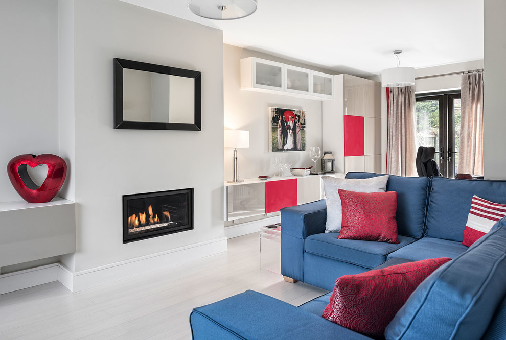 Photo of a small contemporary formal open concept living room in Hampshire with grey walls, a ribbon fireplace, a plaster fireplace surround, grey floor and no tv.