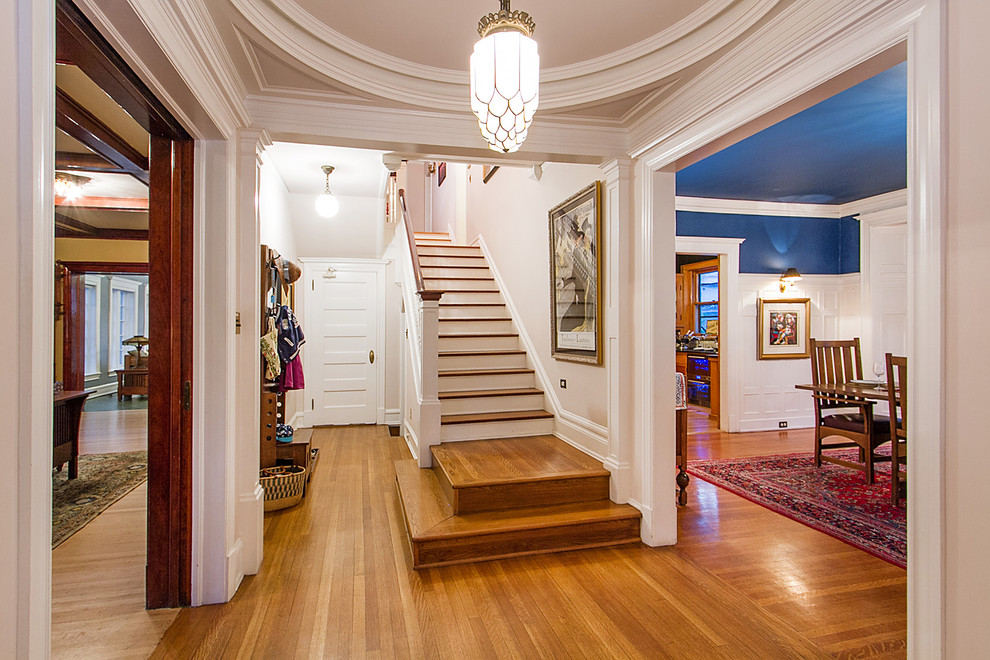 Design ideas for a mid-sized traditional entry hall in Denver with white walls, medium hardwood floors, a single front door, a white front door and brown floor.