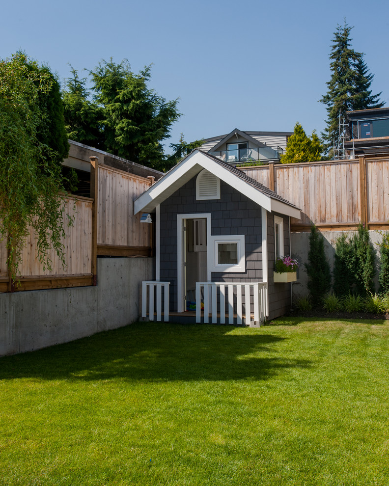 Photo of a mid-sized arts and crafts garden in Vancouver with with outdoor playset.