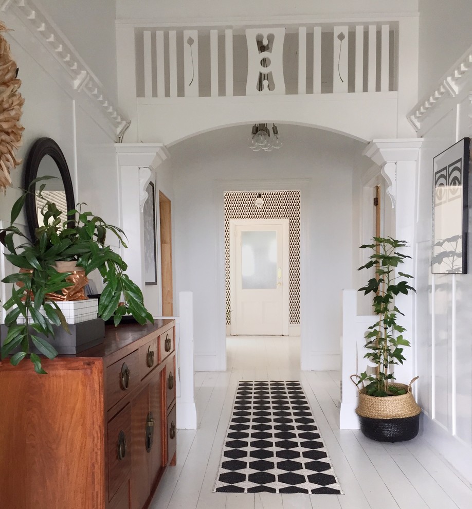 Inspiration for a scandinavian entry hall in Dunedin with white walls and painted wood floors.