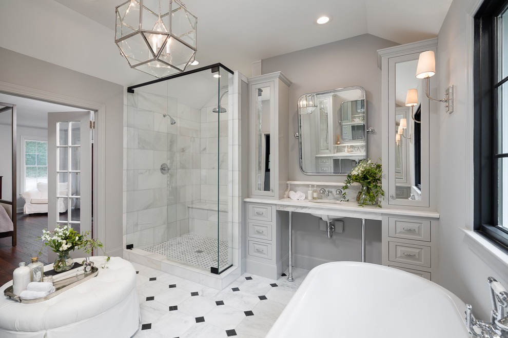 Design ideas for a large traditional master bathroom in Other with grey cabinets, a freestanding tub, a double shower, a one-piece toilet, black and white tile, stone tile, grey walls, marble floors, an undermount sink, marble benchtops and raised-panel cabinets.