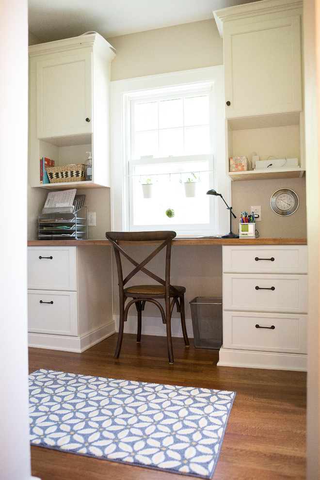 Inspiration for a small transitional home office in Other with medium hardwood floors and a built-in desk.