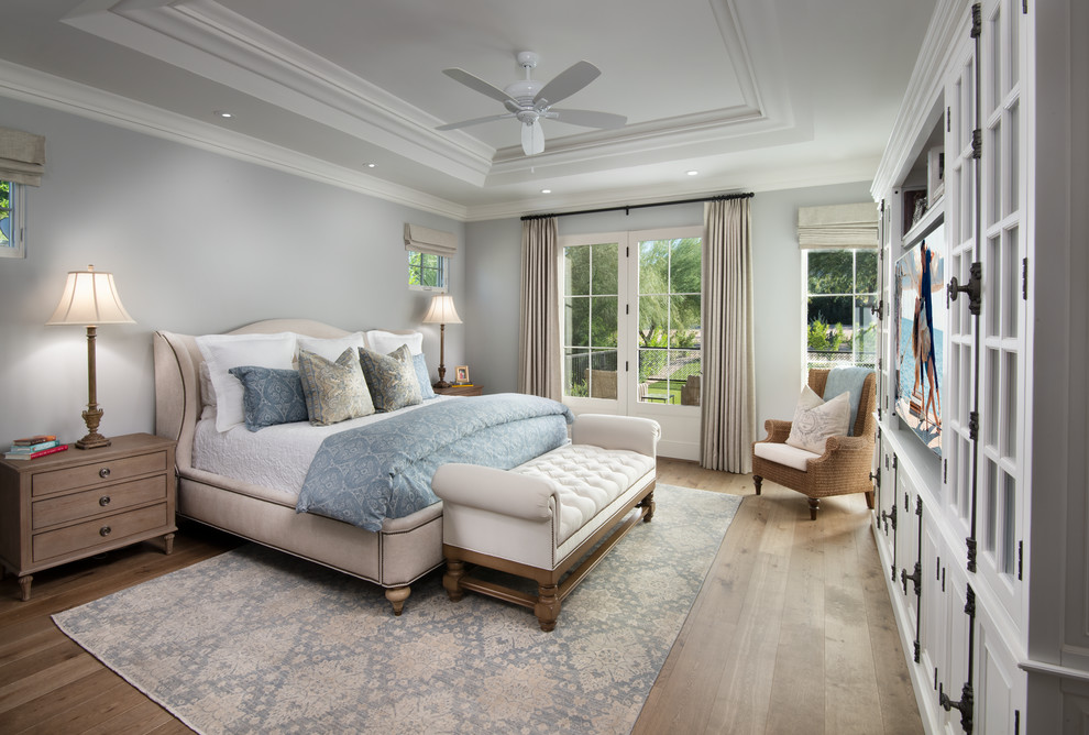 Photo of a mediterranean master bedroom in Phoenix with grey walls, light hardwood floors and no fireplace.
