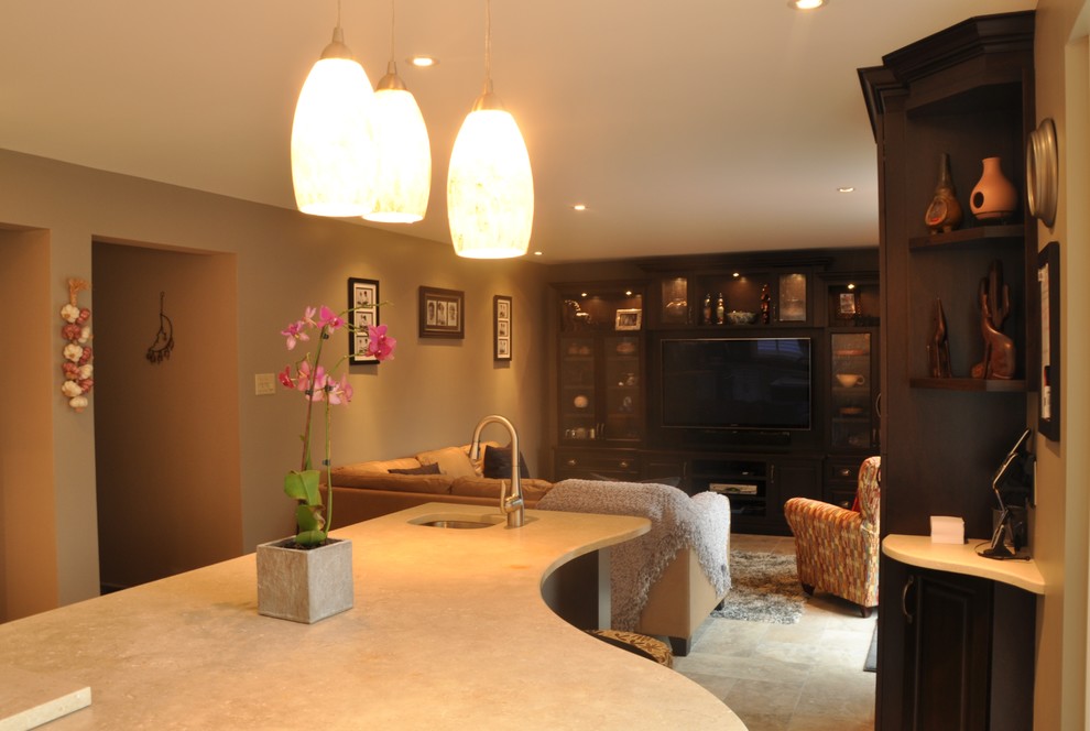 Example of a large transitional l-shaped ceramic tile open concept kitchen design in Ottawa with an undermount sink, raised-panel cabinets, dark wood cabinets, stainless steel appliances and an island