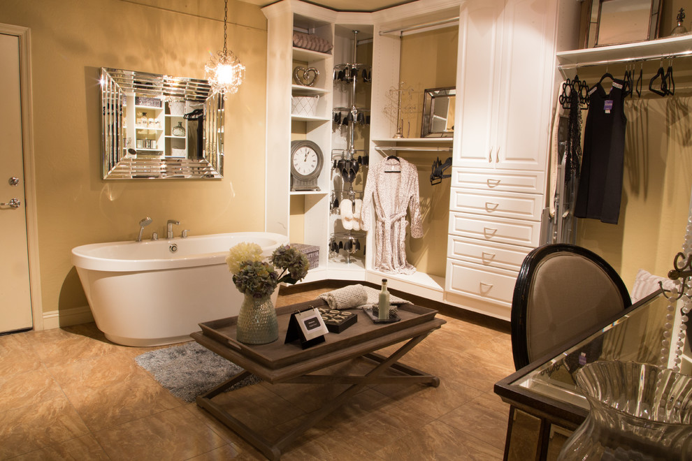 Photo of an expansive traditional women's dressing room in Phoenix with open cabinets, white cabinets and travertine floors.