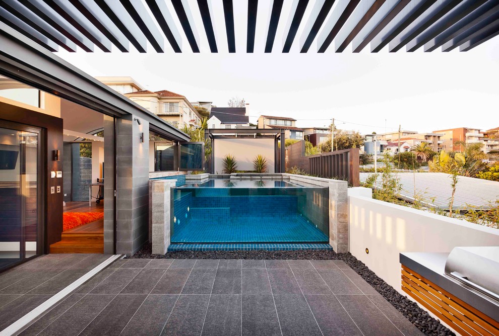 Design ideas for a contemporary courtyard custom-shaped aboveground pool in Sydney.