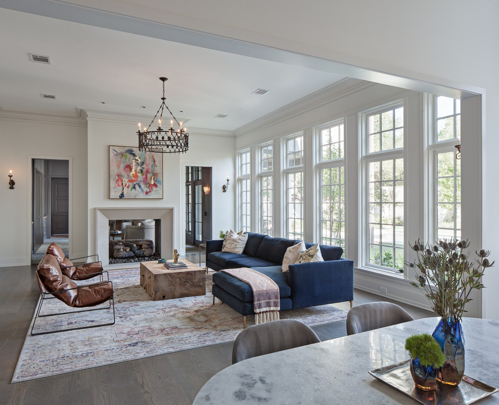 Inspiration for an expansive traditional formal open concept living room in Houston with white walls, a two-sided fireplace, a plaster fireplace surround, no tv and grey floor.