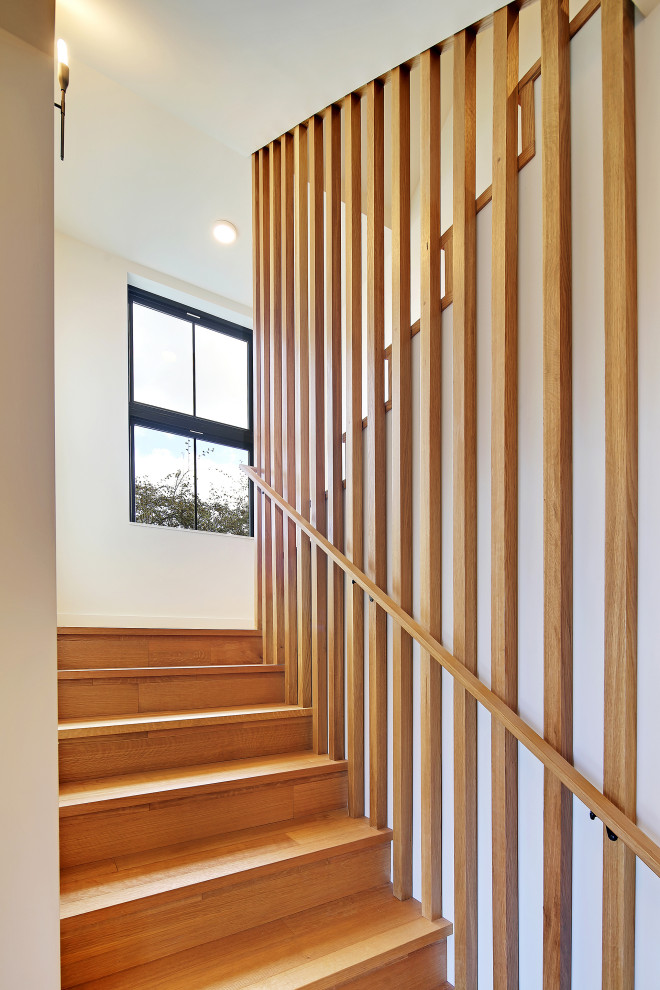 Inspiration for a large scandinavian wood u-shaped staircase in Seattle with wood risers and wood railing.