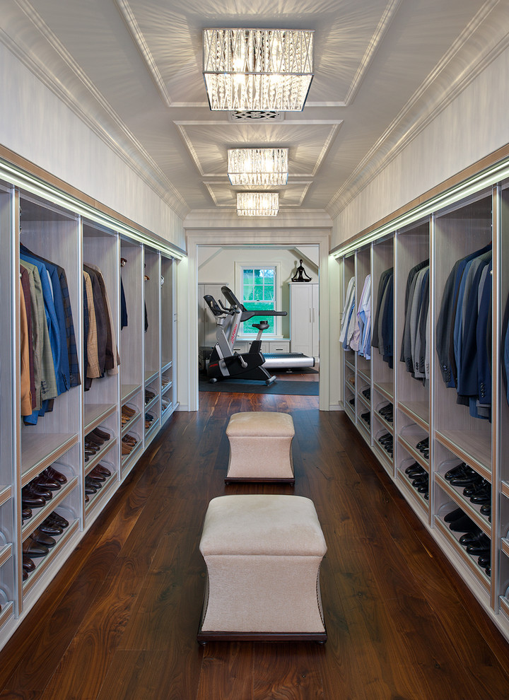 Expansive contemporary men's dressing room in Other with open cabinets, light wood cabinets and light hardwood floors.